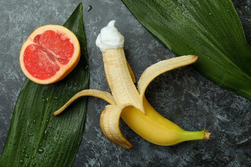 Sex concept with fruits on dark background